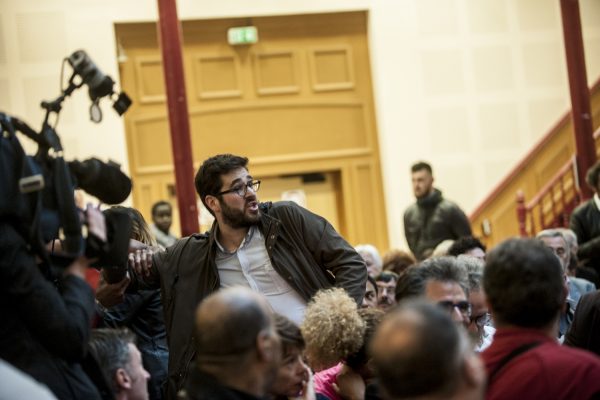 LILLE, FRANCE – JULY 4: An activist against the labor law was introduced in the meeting « Hey oh left, » brandished a poster against the use of 49-3 and went out by the stewards in Lille , France on july 4.
Supporters of the policy of the socialist government, led by Stéphane Le Foll and Patrick Kanner in the region held a meeting, « Hey oh the left » Monday night at the Lille Gymnasium, to restore confidence to the militants and provide them with arguments.