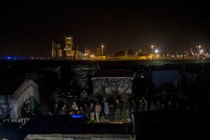 Migrants waiting outside the Belgium Kitchen dinner. About 800 meals are distributed each evening by the volunteer kitchen. In Calais, northern France, February 23, 2016 